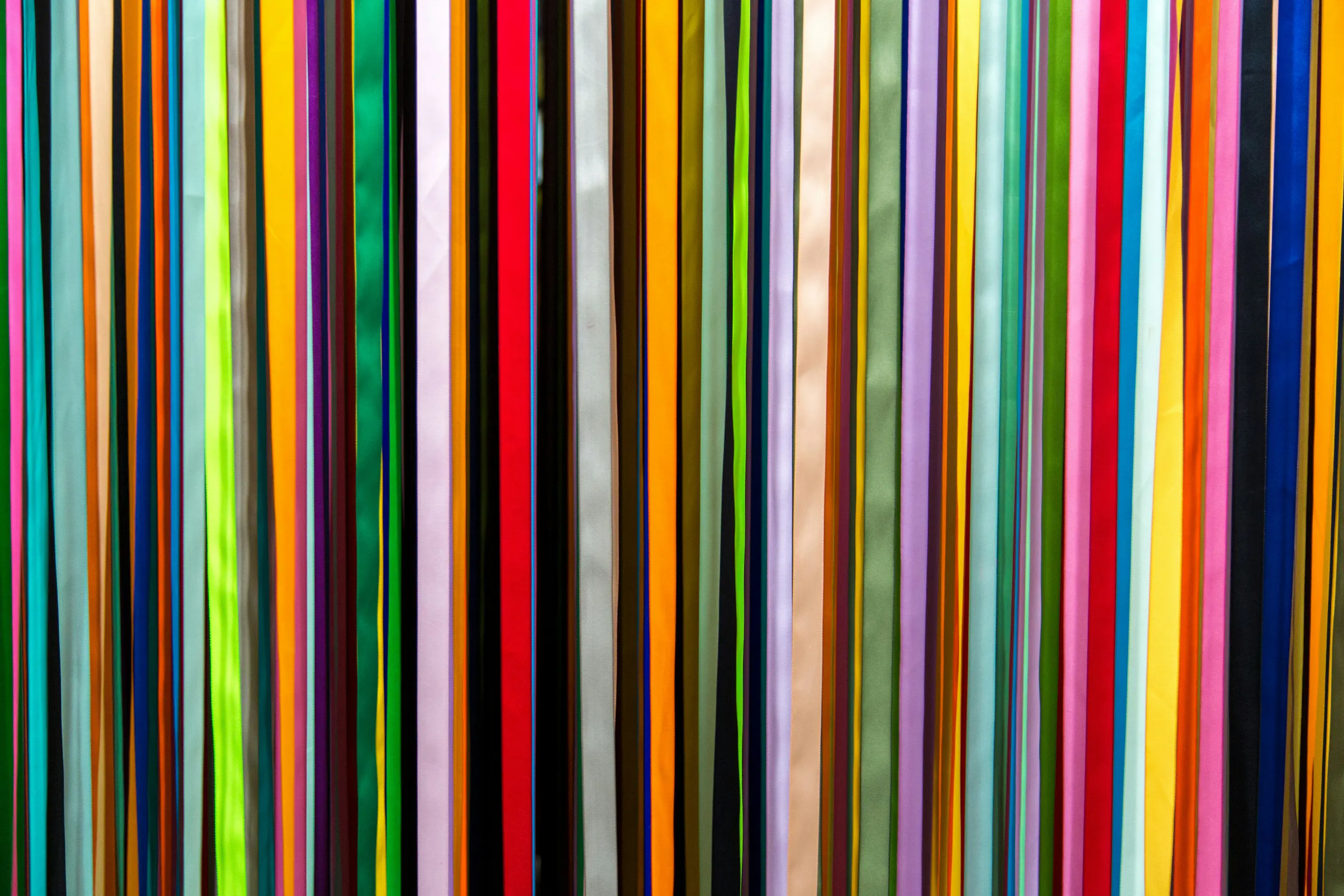 a large group of multicoloured sticks in a row